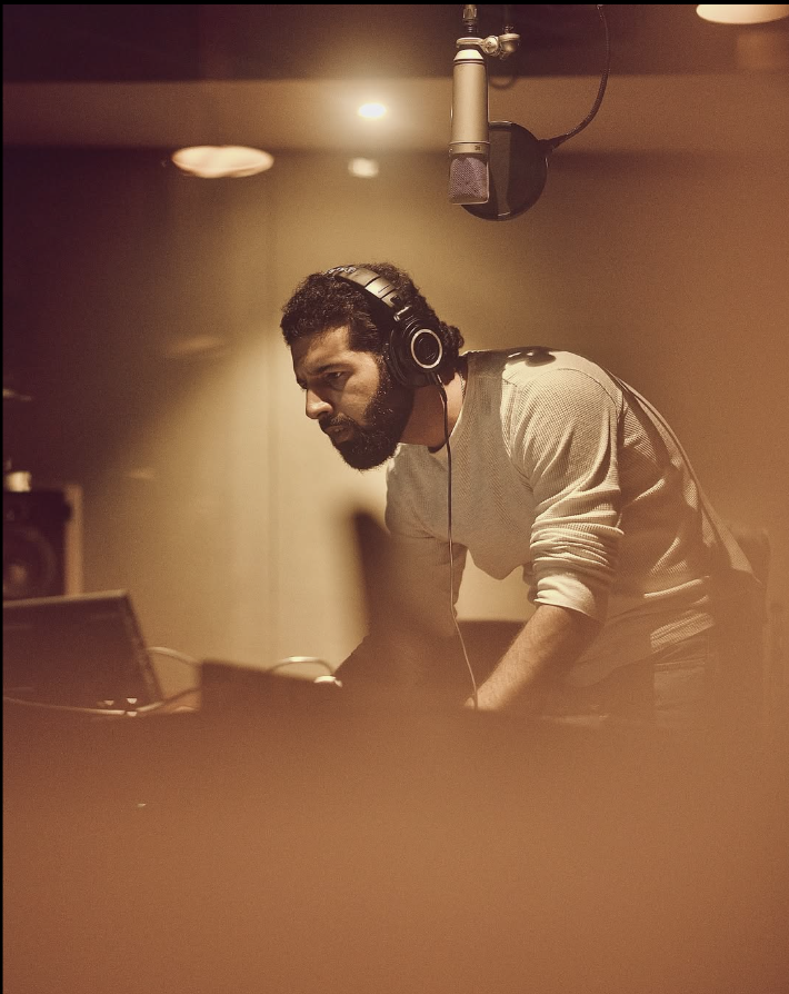 Azamaan behind the console with headphones