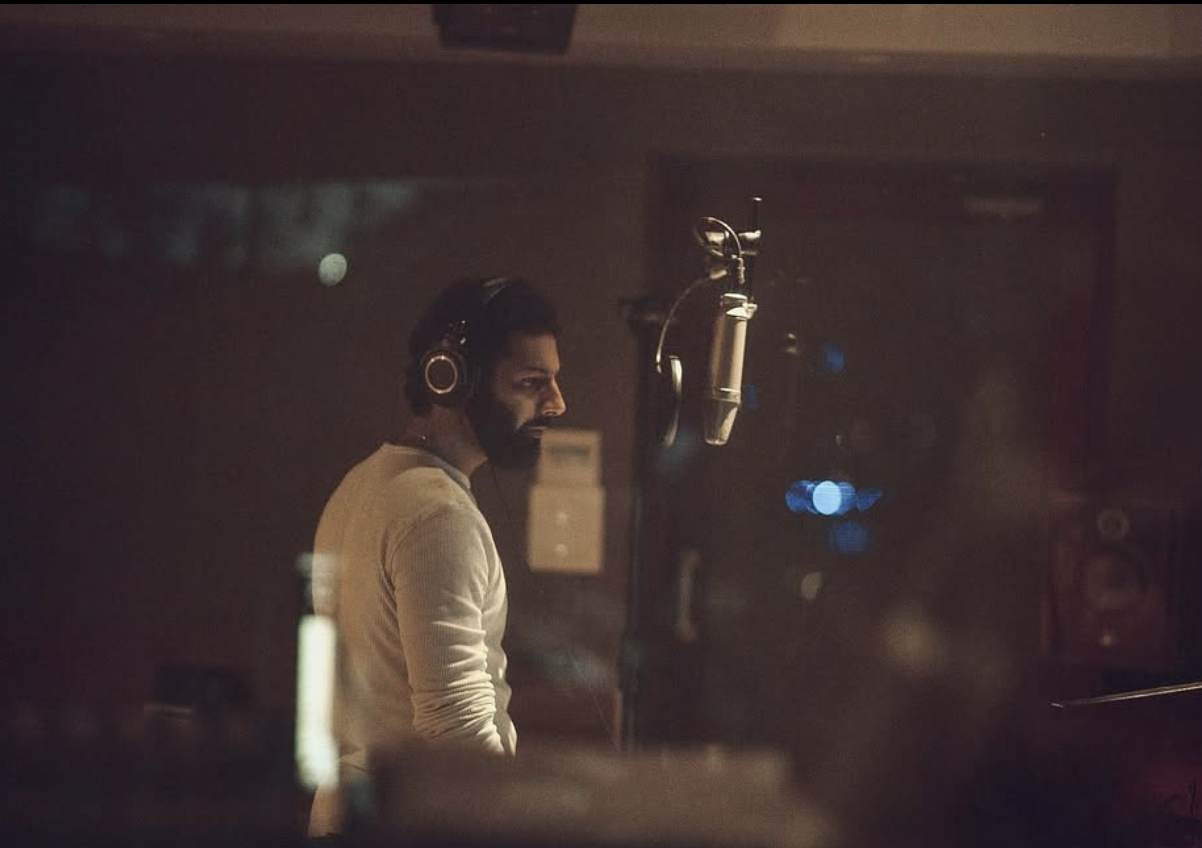 Azamaan at the mic in profile