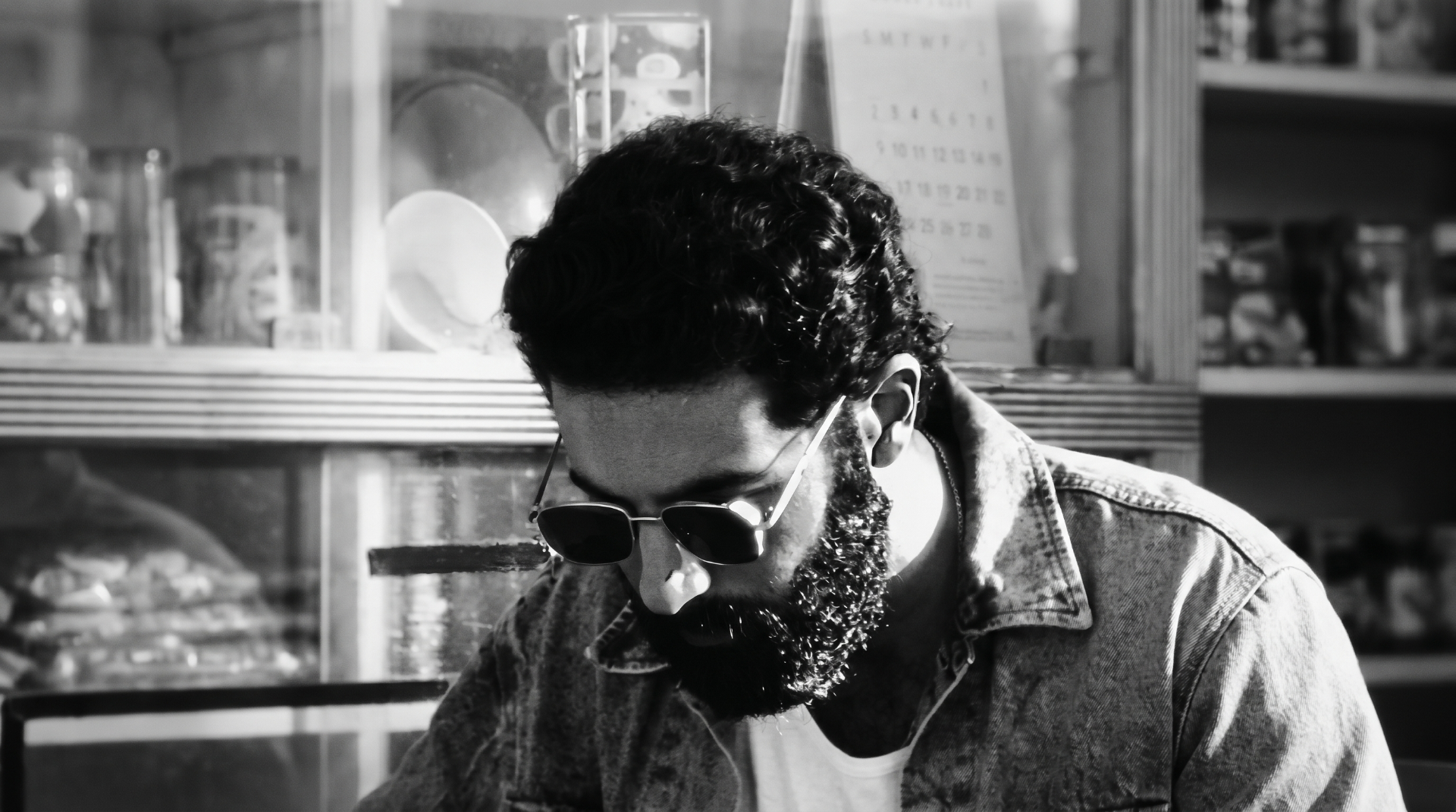 Black and white portrait of Azamaan at a counter