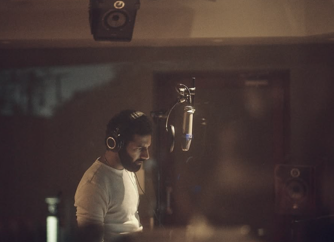 Azamaan tracking vocals in the studio
